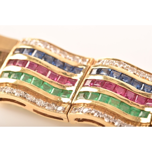 1 - An 18ct yellow gold bracelet, set with calibre cut emeralds, rubies and sapphires, further set with ... 