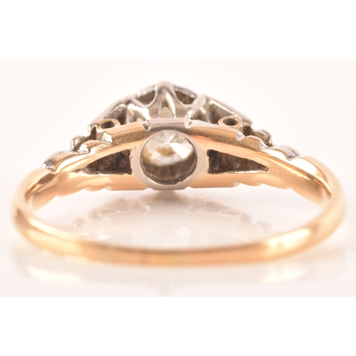 73 - An 18ct yellow gold and platinum vintage diamond solitaire ring, set to centre with a round brillian... 