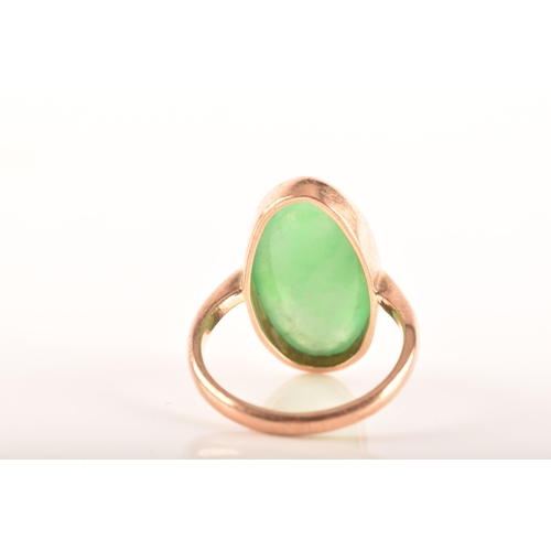 75 - A 9ct yellow gold ring, set with a oval cabochon jadeite measuring approximately 16 x .5 mm, size F,... 