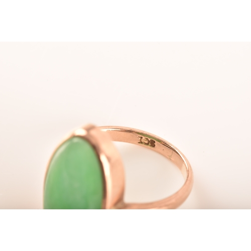 75 - A 9ct yellow gold ring, set with a oval cabochon jadeite measuring approximately 16 x .5 mm, size F,... 