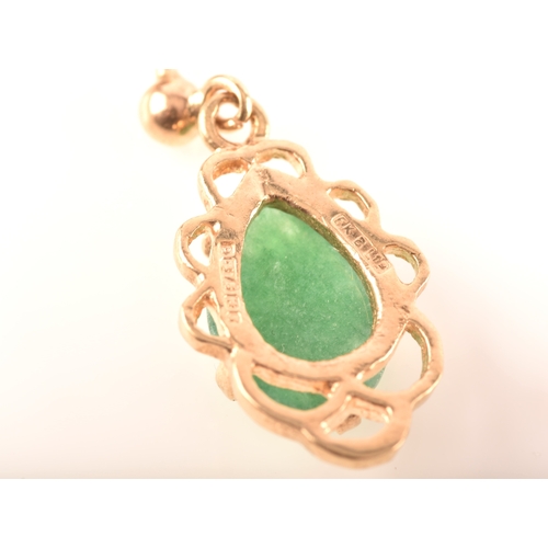 75 - A 9ct yellow gold ring, set with a oval cabochon jadeite measuring approximately 16 x .5 mm, size F,... 