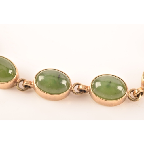 26 - A vintage 9ct yellow gold bracelet, set with thirteen nephrite cabochons, 18cm long.