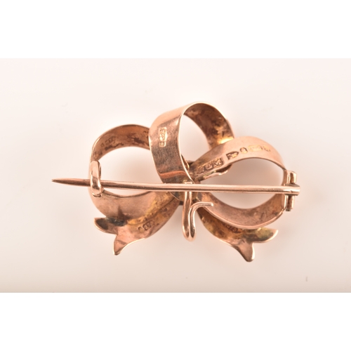 69 - A 15ct yellow gold and nephrite twist brooch, together with a 9ct rose gold bow brooch and a 9ct yel... 