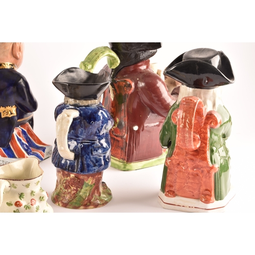 315 - A collection of Staffordshire Toby jugs, including a Staffordshire figure of Nelson, a figure of Win... 