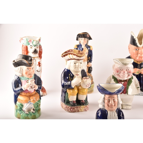 315 - A collection of Staffordshire Toby jugs, including a Staffordshire figure of Nelson, a figure of Win... 