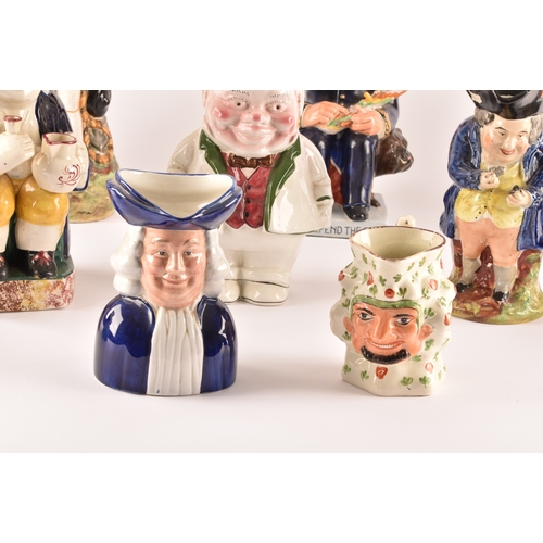 315 - A collection of Staffordshire Toby jugs, including a Staffordshire figure of Nelson, a figure of Win... 