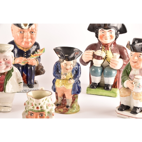 315 - A collection of Staffordshire Toby jugs, including a Staffordshire figure of Nelson, a figure of Win... 