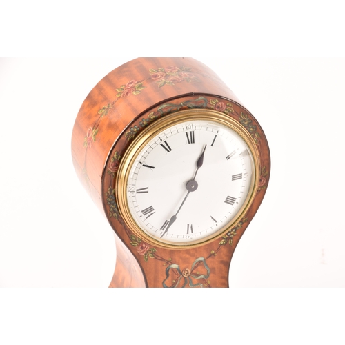 354 - An Edwardian painted satinwood balloon clock with white dial and black Roman numerals, together with... 