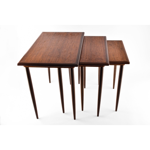 363 - A nest of three Danish rosewood occasional tables, with rounded edges and turned tapering legs, larg... 