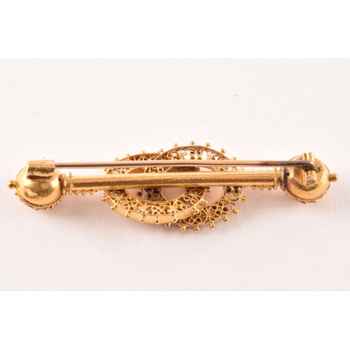 51 - A yellow metal bar brooch with ornate filigree detail, together with a 9ct gold mounted amber cheroo... 