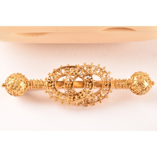 51 - A yellow metal bar brooch with ornate filigree detail, together with a 9ct gold mounted amber cheroo... 