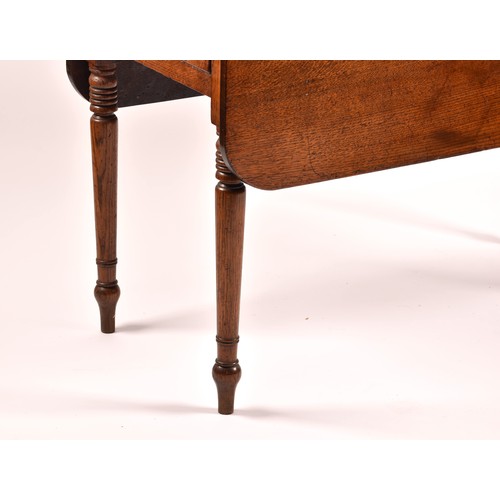 377 - An 18th century oak drop flap Pembroke table, with a pair of folding flaps, end drawer and supported... 