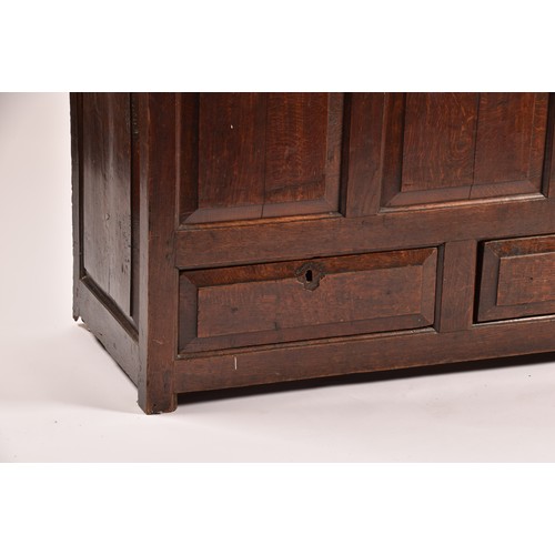 378 - An 18th century oak coffer, with hinged folding lid, triple panelled front over two short drawers, 1... 