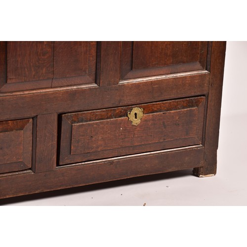 378 - An 18th century oak coffer, with hinged folding lid, triple panelled front over two short drawers, 1... 