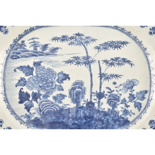 306 - A 19th century Chinese blue and white porcelain meat platter, decorated with a landscape scene of ba... 