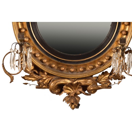 389 - A 19th century convex gilt wall mirror, crested with a carved and gilded dragon and snake, and scrol... 