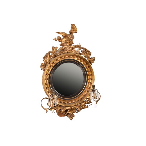 389 - A 19th century convex gilt wall mirror, crested with a carved and gilded dragon and snake, and scrol... 