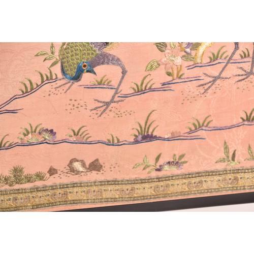 297 - A large Chinese silk work picture, decorated with a central scene of an Asiatic pheasant stood on a ... 