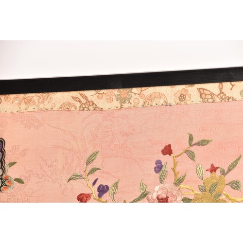 297 - A large Chinese silk work picture, decorated with a central scene of an Asiatic pheasant stood on a ... 