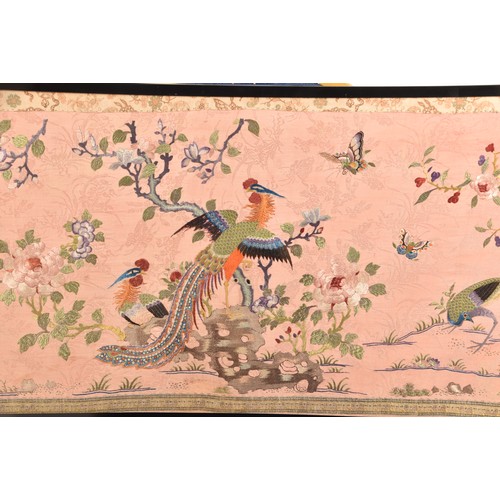 297 - A large Chinese silk work picture, decorated with a central scene of an Asiatic pheasant stood on a ... 