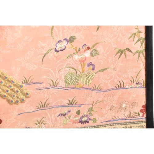 297 - A large Chinese silk work picture, decorated with a central scene of an Asiatic pheasant stood on a ... 