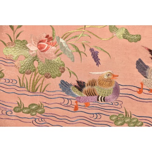 297 - A large Chinese silk work picture, decorated with a central scene of an Asiatic pheasant stood on a ... 