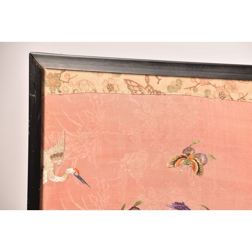 297 - A large Chinese silk work picture, decorated with a central scene of an Asiatic pheasant stood on a ... 