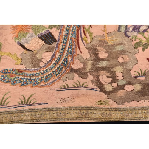 297 - A large Chinese silk work picture, decorated with a central scene of an Asiatic pheasant stood on a ... 