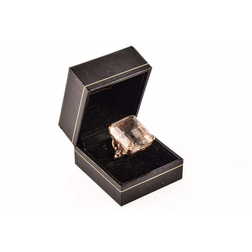 21 - A 9ct gold ring set to centre with a white quartz stone measuring 25mm x 20mm, hallmarked for London... 