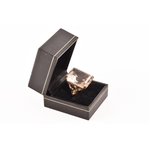 21 - A 9ct gold ring set to centre with a white quartz stone measuring 25mm x 20mm, hallmarked for London... 