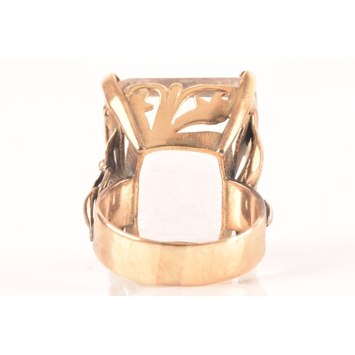 21 - A 9ct gold ring set to centre with a white quartz stone measuring 25mm x 20mm, hallmarked for London... 