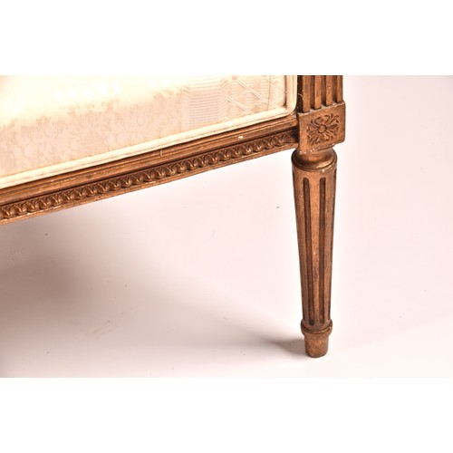 380 - A French 19th century Louis XVI style giltwood salon suite, comprising a settee, a pair of armchairs... 