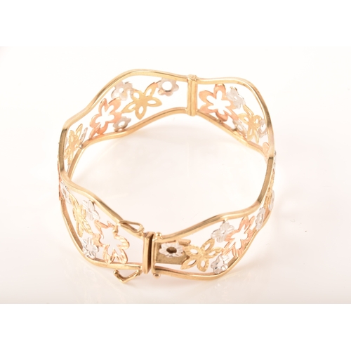 23 - A 9ct white, rose and gold openwork floral bracelet, 6cm, 11 grams, in presentation box.