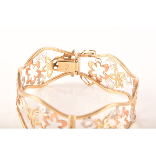 23 - A 9ct white, rose and gold openwork floral bracelet, 6cm, 11 grams, in presentation box.