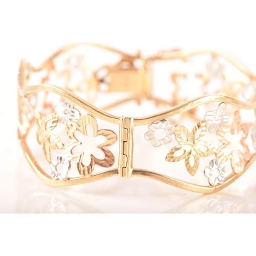 23 - A 9ct white, rose and gold openwork floral bracelet, 6cm, 11 grams, in presentation box.