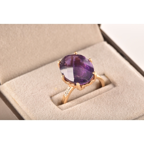 32 - A large 18ct yellow gold amethyst solitaire ring, set to centre with a oval checkerboard cut amethys... 