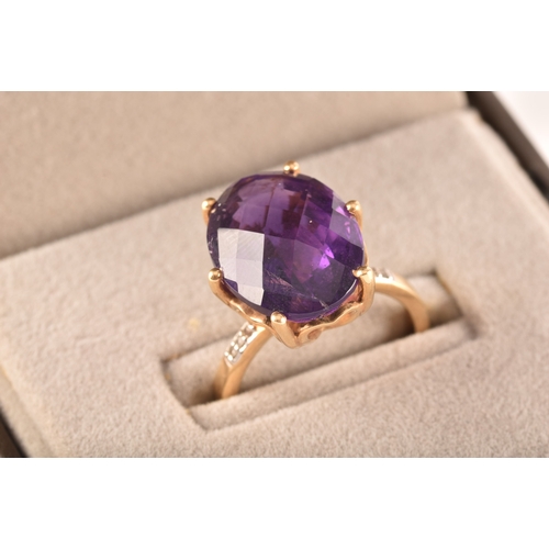 32 - A large 18ct yellow gold amethyst solitaire ring, set to centre with a oval checkerboard cut amethys... 