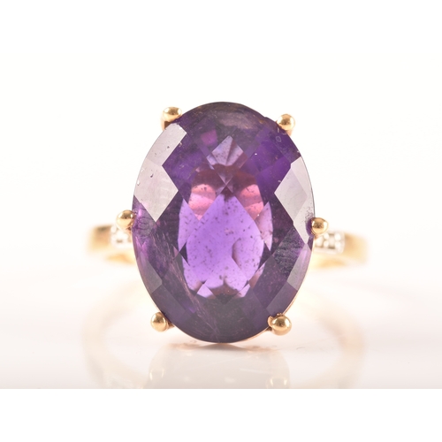 32 - A large 18ct yellow gold amethyst solitaire ring, set to centre with a oval checkerboard cut amethys... 