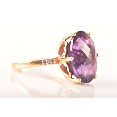 32 - A large 18ct yellow gold amethyst solitaire ring, set to centre with a oval checkerboard cut amethys... 