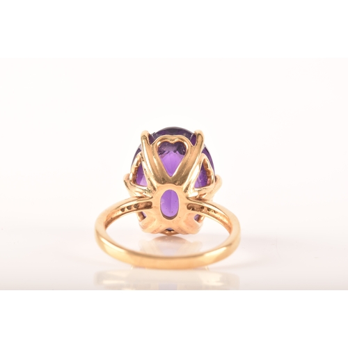 32 - A large 18ct yellow gold amethyst solitaire ring, set to centre with a oval checkerboard cut amethys... 