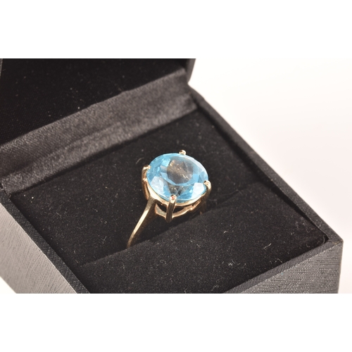 94 - A 10ct yellow gold topaz ring, set with a round blue topaz with an approximate weight of 7.30 carats... 