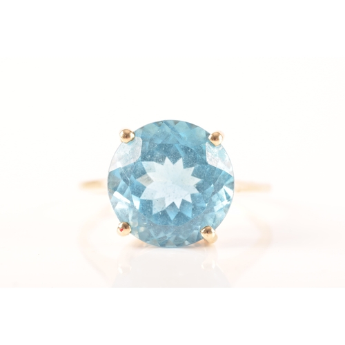 94 - A 10ct yellow gold topaz ring, set with a round blue topaz with an approximate weight of 7.30 carats... 