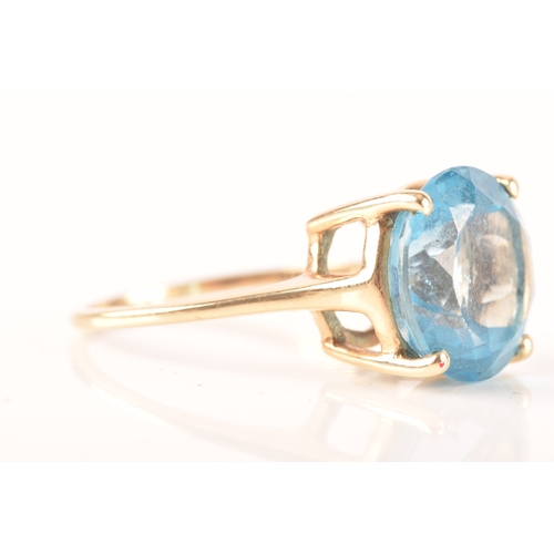 94 - A 10ct yellow gold topaz ring, set with a round blue topaz with an approximate weight of 7.30 carats... 