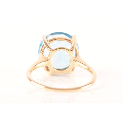 94 - A 10ct yellow gold topaz ring, set with a round blue topaz with an approximate weight of 7.30 carats... 