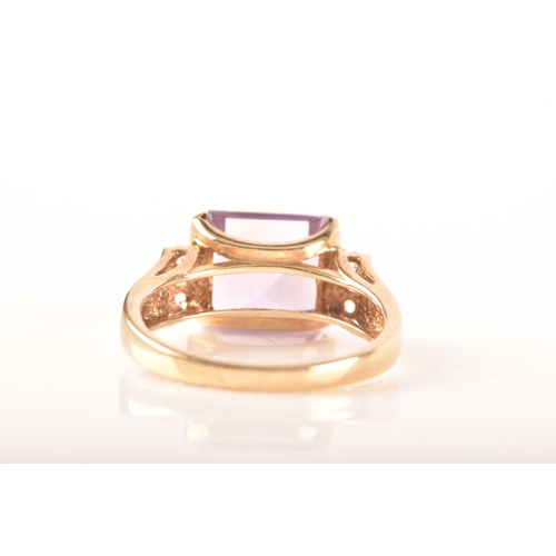 31 - A 9ct yellow gold amethyst and diamond ring, set to centre with a rectangular amethyst with an appro... 