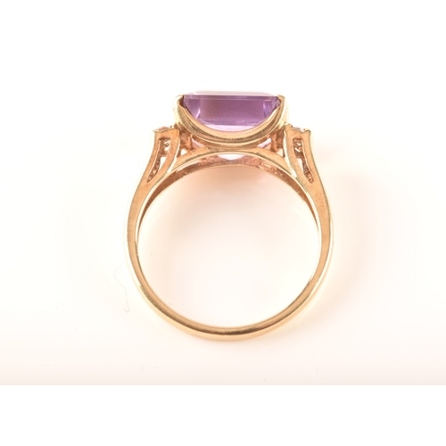 31 - A 9ct yellow gold amethyst and diamond ring, set to centre with a rectangular amethyst with an appro... 