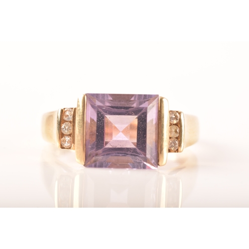 31 - A 9ct yellow gold amethyst and diamond ring, set to centre with a rectangular amethyst with an appro... 