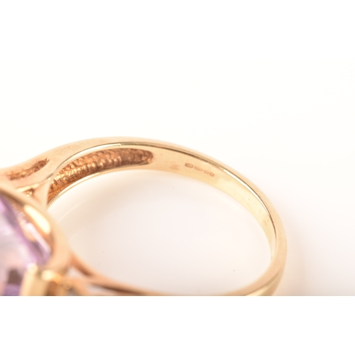 31 - A 9ct yellow gold amethyst and diamond ring, set to centre with a rectangular amethyst with an appro... 