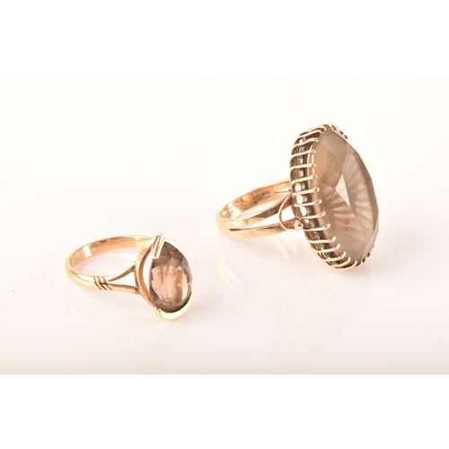 16 - An 18ct yellow gold dress ring set to centre with a large oval smoky quartz, measuring 25 x 18mm, si... 