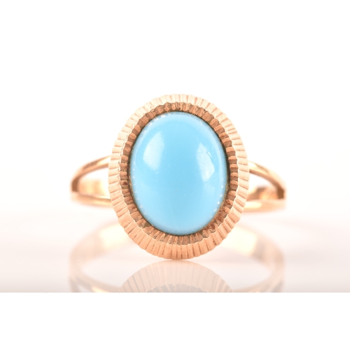 92 - A yellow metal ring set with a oval cabochon turquoise, measuring approximately 10 x 8mm, size K.